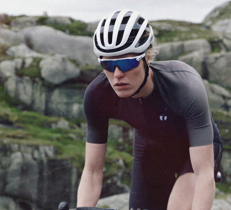 Triathlete biking in Trimtex Drive triathlon suit in the Nordic Grit