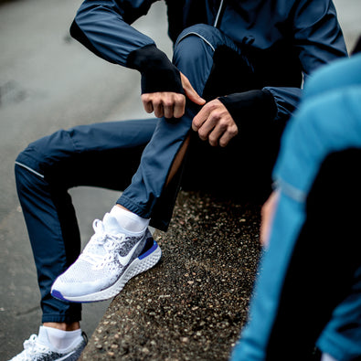 Jogger wearing his trainer jacket and pants on a jog.