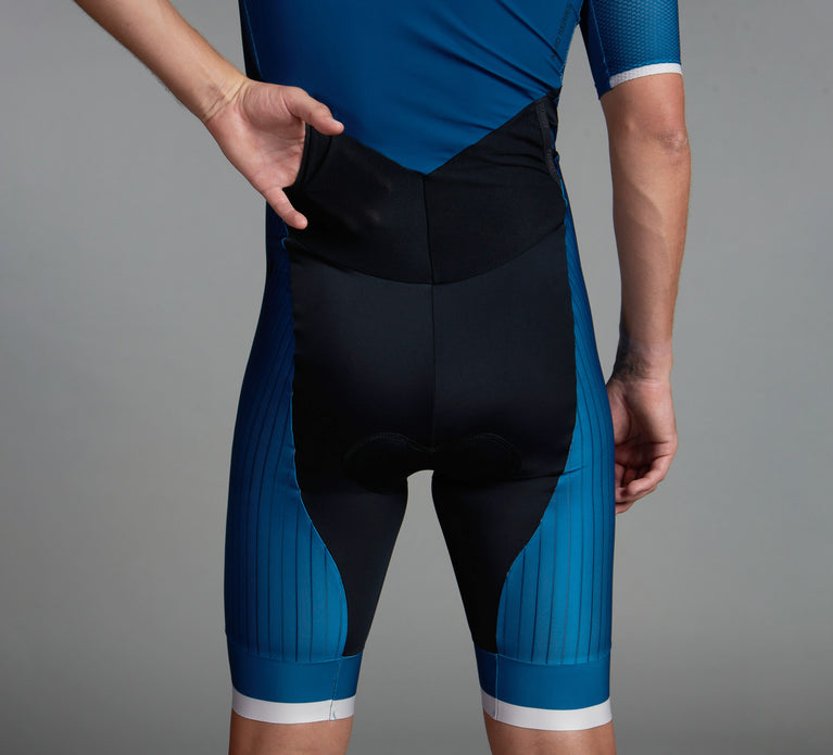 Triathlete showing one of the two backpockets for gels and bars on the Aero 3.0 speedsuit for men