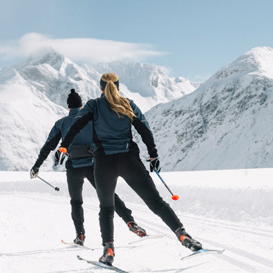 Two people skiing in their Trimtex Ambition skiing jacket and pants