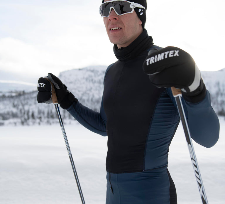 Male skiier standing at the ski tracks wearing Trimtex Ace Racesuit.