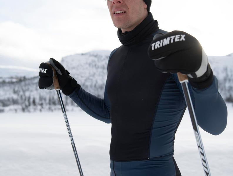 Male skiier standing at the ski tracks wearing Trimtex Ace Racesuit.