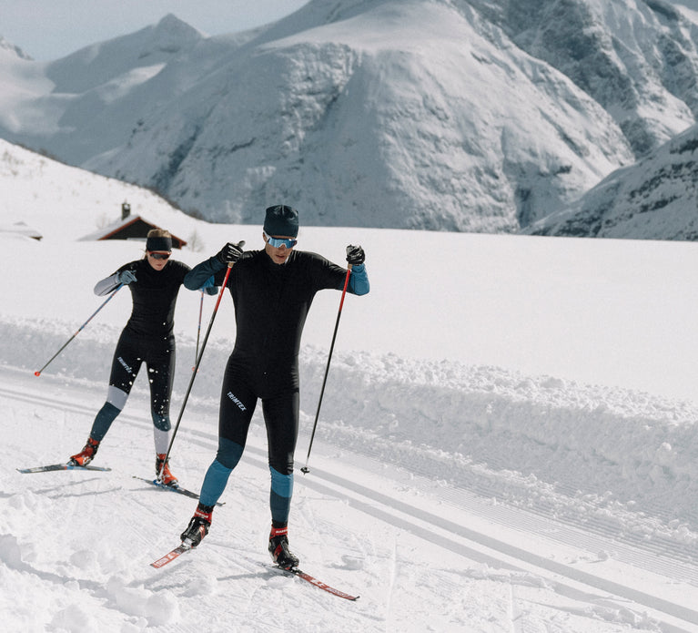 Skiers wearing the Trimtex Vision racesuit while skiing in the mountain