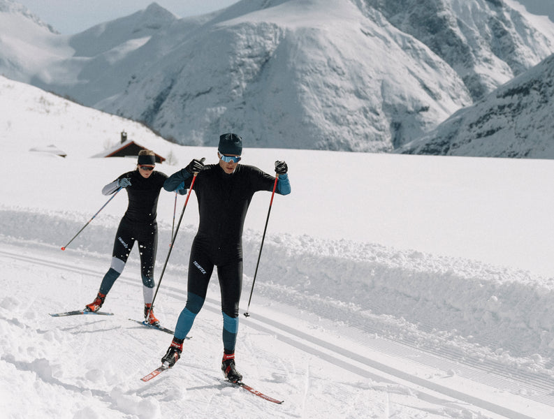 Skiers wearing the Trimtex Vision racesuit while skiing in the mountain