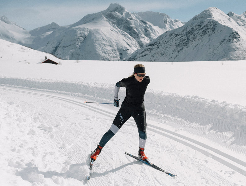 Woman skiing alone in the mountain wearing competition skiwear Vision shirt and tights from Trimtex