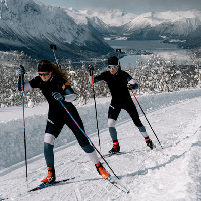 Biathletes skiing up the hill in Trimtex Biathlon Ace Racesuits.