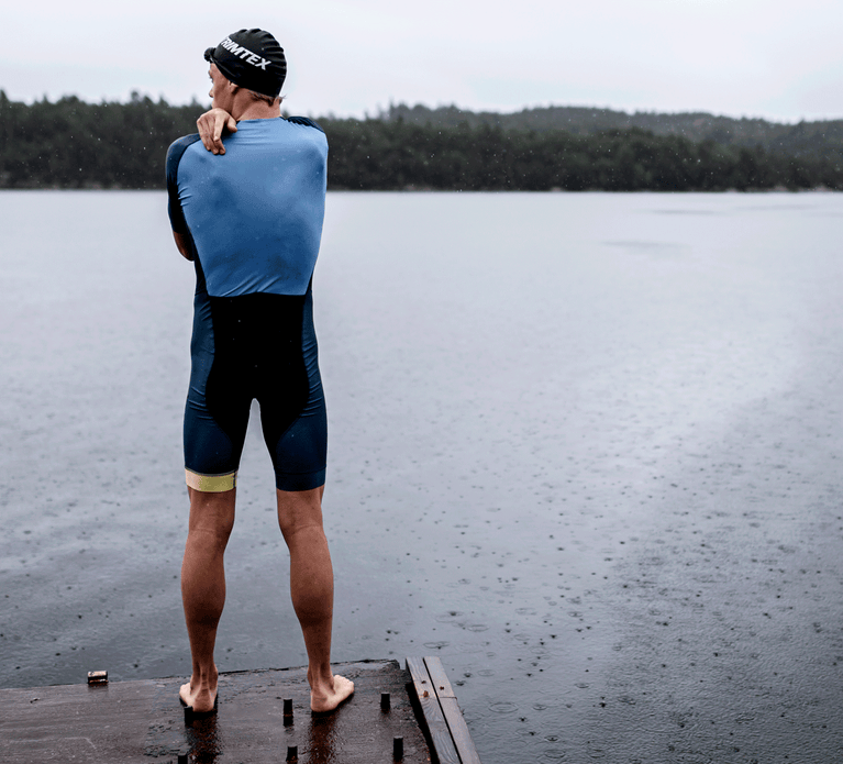 Triathlete ready to jump in the cold water in his Trimtex Drive Speedsuit