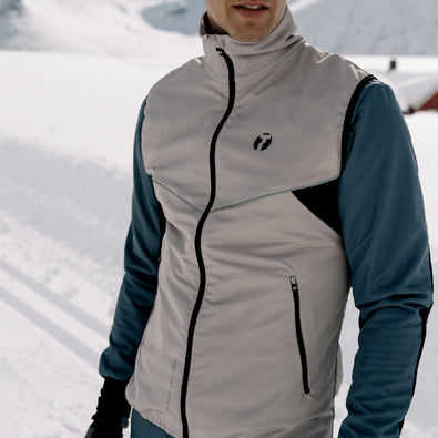 Skiier standing, wearing Trimtex Pulse Vest and Jacket.