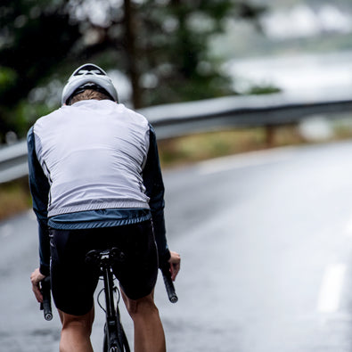Triathlete wearing Trimtex Venom cycling vest, bib shorts and jacket.