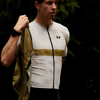 Cyclist wearing vitric cycling shirt putting on Trimtex cycling vest
